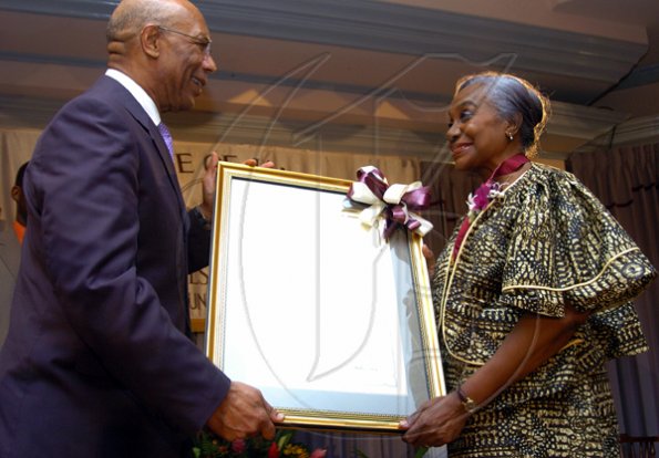 Peta-Gaye Clachar/Freelance Photographer
Governor General of Jamaica Honourable Sir Patrick Allen present the Gold Musgrave Award and citation to Professor Maureen Warner-Lewis for her contribution to Literature  at the Institute of Jamaica (IOJ) Musgrave Awards ceremony at IOJ on Wednesday, October 14, 2009.