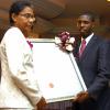 Peta-Gaye Clachar/Freelance Photographer
Senator Warren Newby representing the Minister of Youth, Sports and Culture Honourable Olivia Babsy Grange presents Professor Helen Jacobs with a silver medal and citation for her contribution to Organic Chemistry at the Institute of Jamaica (IOJ) Musgrave Awards ceremony at IOJ on Wednesday, October 14, 2009.