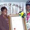 Peta-Gaye Clachar/Staff Photographer
Minister Youth Sports and Culture Olivia 'Babsy' Grange present a citation after receiving the Musgrave Gold Medal to Ras Junior Manning for his contribution to Rastafari at the Institute of Jamaica Musgrave Medals Awards Ceremony at the Institute of Jamaica on Thursday, May 28, 2009.