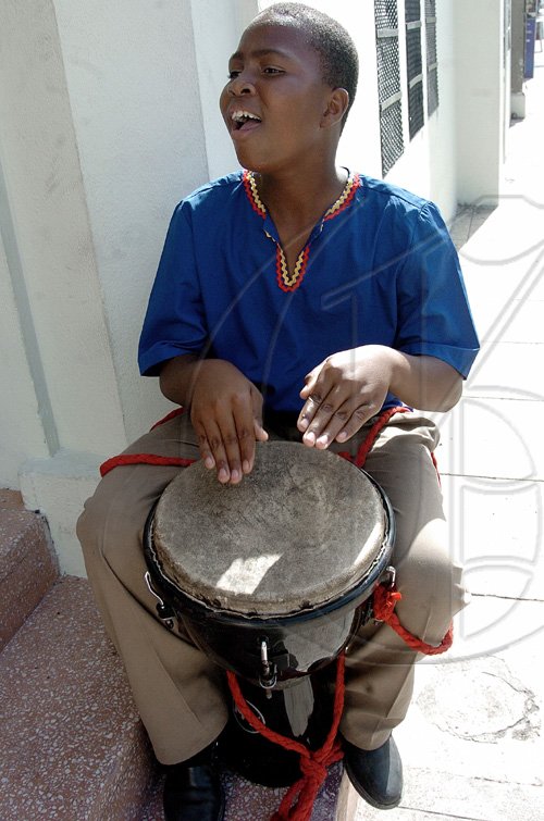Peta-Gaye Clachar/Staff Photographer
This junior member of the Akwaaba drummers beet the drums at the entrance of the Institute of Jamaica to welcome guests arrivng at the Institute's Musgrave Medals Awards Ceremony on East Street on Thursday, May 28, 2009.