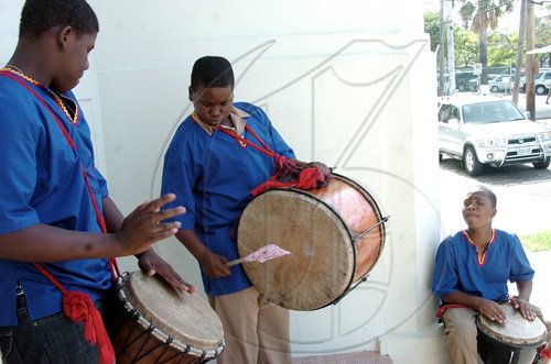 Peta-Gaye Clachar/Staff Photographer
Junior members of the Akwaaba drummers beet the drums at the entrance of the Institute of Jamaica to welcome guests arrivng at the Institute's Musgrave Medals Awards Ceremony on East Street on Thursday, May 28, 2009.