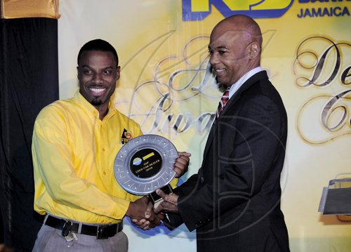 Winston Sill / Freelance PhotographerCrichton Automotive won the Used Car Dealer of the Year (2009/2010) and Jermaine Blair (left) accepts the award from Dennis Cohen, deputy group managing director of National Commercial Bank.*********************************************************(NCB) Auto Dealers Awards Ceremony, held at Terra Nova All-Suite Hotel, Waterloo Road on Tuesday night April 5, 2011.