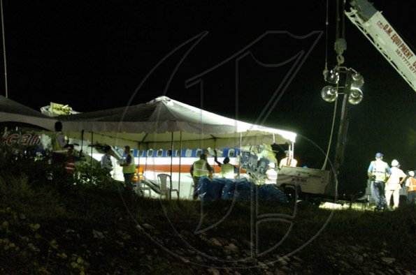 Winston Sill / Freelance Photographer
Removal of crash American Airlines aircraft from the crash site, off Port Royal Road, on Monday night December 28, 2009. Winston Sill / Freelance Photographer
Removal of the middle section of the  crashed  American Airlines aircraft from the crash site, off Port Royal Road, on Monday night December 28, 2009.