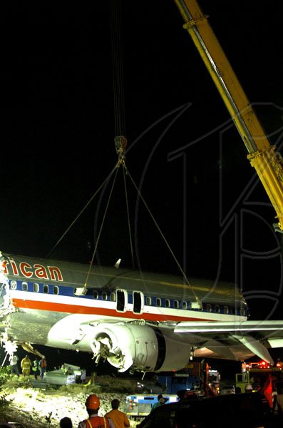 Winston Sill / Freelance Photographer
Removal of crash American Airlines aircraft from the crash site, off Port Royal Road, on Monday night December 28, 2009. Winston Sill / Freelance Photographer
Removal of the middle section of the  crashed  American Airlines aircraft from the crash site, off Port Royal Road, on Monday night December 28, 2009.