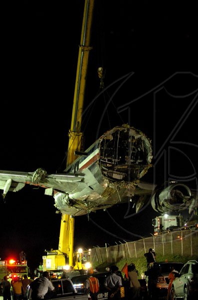 Winston Sill / Freelance Photographer
Removal of crash American Airlines aircraft from the crash site, off Port Royal Road, on Monday night December 28, 2009. Winston Sill / Freelance Photographer
Removal of the middle section of the  crashed  American Airlines aircraft from the crash site, off Port Royal Road, on Monday night December 28, 2009.