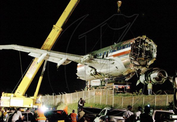 Winston Sill/Freelance Photographer
The middle section of American Airlines Flight 331is removed, on Monday night, from the site at which it came to stop after it overshot the runway at the Norman Manley International Airport in Kingston last week.