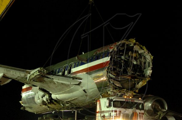 Winston Sill / Freelance Photographer
Removal of crash American Airlines aircraft from the crash site, off Port Royal Road, on Monday night December 28, 2009. Winston Sill / Freelance Photographer
Removal of the middle section of the  crashed  American Airlines aircraft from the crash site, off Port Royal Road, on Monday night December 28, 2009.