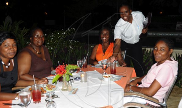 Sheena Gayle/Gleaner Writer
(clockwise) Andrea Richards, Keitha Osborne, Cloverlyn Newman, Jeroldine Campbell (Seahorse Grill waitress) and Merlene Blake seemed to enjoy a night out during Restaurant Week at Robbie Joseph?s Seahorse Grill in Montego Bay on Wednesday.