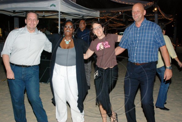 Janet Silvera Photo
 
Not sure if these four from left:  TUI's Steffen Boehnke;  RIU's Angella Bennett, Annette Schmid and Armin Kaestner are trying to do the macarena in the sand, but we know they danced the night away.

********************************************************************** to Byron Lee and the Dragonniare's band at the RIU Ocho Rios TUI Deutschland beach party last Thursday night.