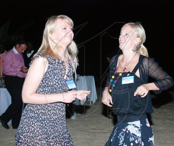 Janet Silvera Photo

TUI Deutschland's Katrina Steier (left) and Dela Husken enjoying a night on the beach at RIU Ocho Rios hosted party for some 100 media practicioners who were on the island for the TUI educational summer programme.

************************************************************************* last Thursday.