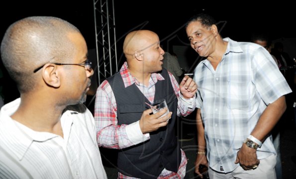 Rudolph Brown/Photographer
Mark Chisholm, (centre) vice president, Individual Life Sales, Sagicor chat with Willard Brown, (left) and Albert Lyon at the Sagicor christmas party at the Office car park in New Kingston on Saturday, December 12-2009