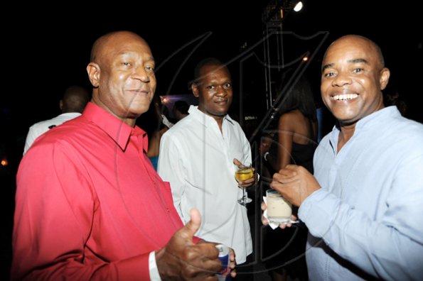 Rudolph Brown/Photographer
Randolph McLean,(left) Knutsford Branch Manager chat with Calvin Smith, (right) and John Tulloch at the Sagicor christmas party at the Office car park in New Kingston on Saturday, December 12-2009