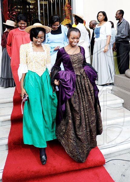 Rudolph Brown/Photographer
Shauna Roper (left) and Ellese Ricketts shed regular uniforms for colourful retro outfits.

*****************************************************************************staff of Scotiabank walk on the red carpet during the Scotiabank Jamaica celebrating 120 years in Jamaica from 1889 to 2009 at the Kings Street Branch on Monday, December 14-2009