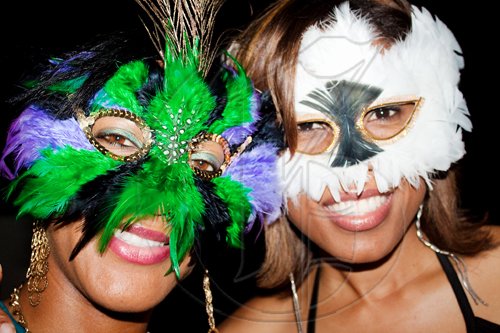 Behind the masks, Diageo's Keri-Ann McKenzie (left) and Semone Thaxter, get their groove on at the masquerade-themed event, Twisted Spiritz.