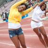 Warming up has never looked so cute! Tanya Lee, (left) Regional Marketing Manager for SportsMax Limited, does a winning stretch along with Amelia 'Milk' Sewell, shortly before taking the gold in the female corporate 100m sprint at Ash Wednesday's Bob Marley One Love Charity Celebrity Football Matches and Celebolympics.