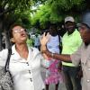Ian Allen/Staff Photographer
An Inspector of Police tried to restrain Elaine Elliston outside the Supreme Court along King Street after she got in the Spirit while awaiting the Michael Stern/ Richard Azan verdict on the dual citizenship case in  the North West Clarendon constituency.