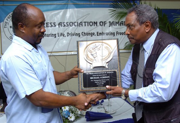 Peta-Gaye Clachar/ Freelance Photographer
President of the Press Association of Jamaica Mr. Byron Buckley (left) present an award to Mr. Michael Gordon for his outstanding contribution and service at a Veterans' Luncheon hosted by the Press Association of Jamaica at the Girl Guides Association on Wednesday, December 2, 2009. Mr. Winston Sill Photographer at the Gleaner Company , Mr. Ken Dawson Videographer formerly at TVJ and Mr. Ruddy Mattherson a Videographer were also honoured.
