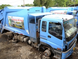 Out of service trucks belonging to the National Solid Waste Management Agency parked at a garage on Hagley park road in St. Andrew.