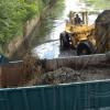 Norman Grindley /Deputy Chief Photographer 
A tractor driver load a truck with mud and garbage from the Waterford main drain during a gully cleaning in Portmore yesterday.