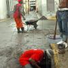 Norman Grindley /Deputy Chief Photographer 
Workmen from KSAC clear blocked drains along Harbour Street in Kingston yesterday.